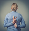businessman showing two fingers behind his back