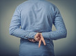 businessman showing two fingers behind his back