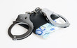 Foto: Black leather wallet with handcuffs isolated over white Black leather wallet with handcuffs isolated over white