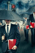 Businessman with umbrella in the rain