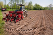 Photo: Old tractor with red sower working fields wide angle Old tractor with red sower working fields wide angle