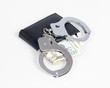 Foto: Black leather wallet with handcuffs isolated over white Black leather wallet with handcuffs isolated over white