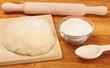 dough,  flour,  rolling pin, spoon on  wooden table