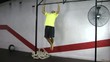 Athlete making strict pull ups crossfit exercise