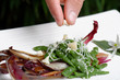 Closeup of chef adding finishing touch on his dish