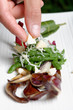 Closeup of chef adding finishing touch on his dish