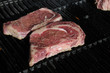 Ribeye steaks cooking on a gas barbecue