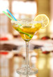 Yellow cocktail in glass on room background