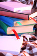 Many books with bookmarks on plaid close-up