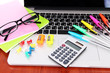 Laptop with stationery on table