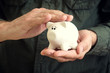 Photo: Piggy coin bank in hands Piggy coin bank in hands