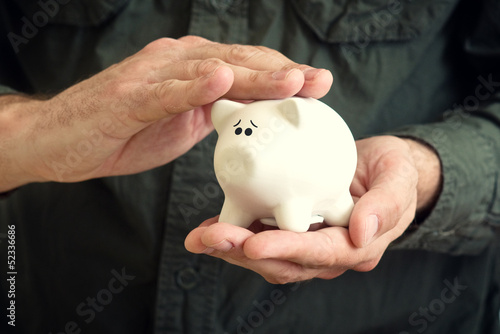 Photo: Piggy coin bank in hands Piggy coin bank in hands