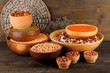 Different kinds of beans in bowls on wooden background