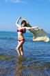 Gorgeous woman in the water having fun with the wind