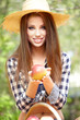 Beautiful woman in the garden with apples