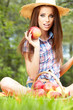 Beautiful woman in the garden with apples