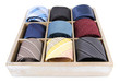 Neckties in wooden box isolated on white