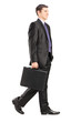Full length portrait of a businessman walking and holding a brie