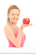 Young smiling female holding a red apple