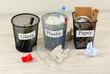 Three buckets of assorted debris on room background