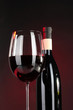 Wine in glass and wine bottle close-up on dark background
