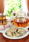 Tasty halva with tea on table in room