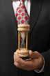 Businessman holding hourglass