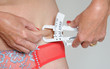 Woman checking her body fat measurement
