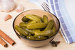 pickled cucumbers in a plate on a wooden surface