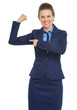 Smiling business woman pointing on biceps