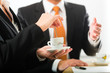 Photo: businesspersons in business office drinking coffee businesspersons in business office drinking coffee