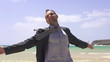 Happy businessman on the beach, super slow motion, shot at 240fp
