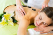 Foto: woman having wellness hot stone massage woman having wellness hot stone massage