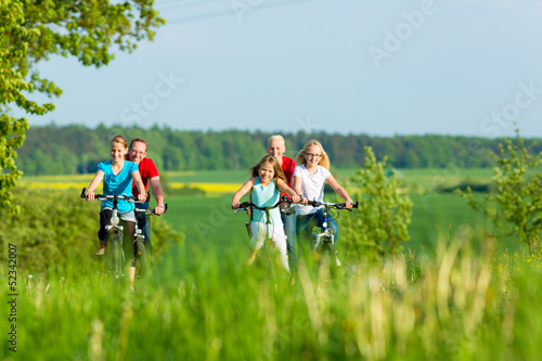 Photo: Family cycling outdoors in summer Family cycling outdoors in summer