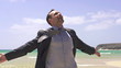 Happy young businessman on beautiful exotic beach