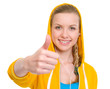 Happy teenager girl in earphones showing thumbs up