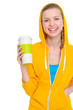 Photo: Portrait of happy teenager girl holding coffee cup Portrait of happy teenager girl holding coffee cup