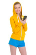Smiling teenager girl writing sms
