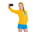 Photo: Happy teenager girl taking photo with cell phone Happy teenager girl taking photo with cell phone