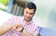 Happy guy have a date, checking the time