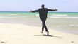 Excited businessman running on the beach, super slow motion