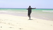 Excited businessman running on the beach