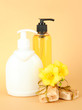 Liquid and hand-made soaps on beige background