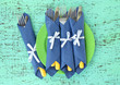 Forks and knives wrapped in blue paper napkins,