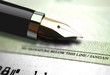 Close up on cheque with an ink pen