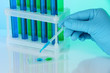 Identical test tubes and hand close-up