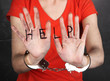 Prisoner in handcuffs behind glass in soundproof room