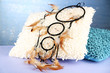Beautiful dream catcher and pillows on blue background