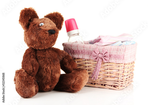 Photo: Beautiful basket of baby clothes isolated on white Beautiful basket of baby clothes isolated on white