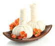 Herbal compress balls for spa treatment and flowers isolated